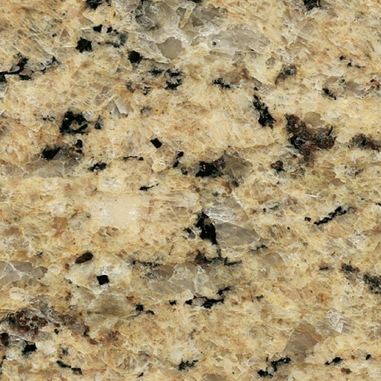 Muster aus goldenem und braunem Granit mit schwarzen Einschlüssen.
