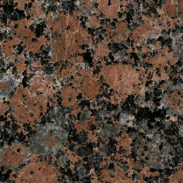 Muster aus rötlichem Granit mit dunklen und hellen Einsprenkelungen.
